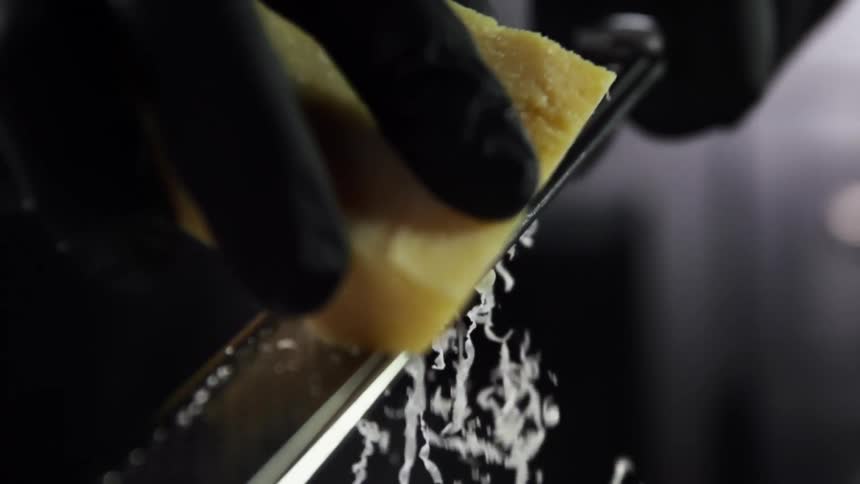 A person grating cheese