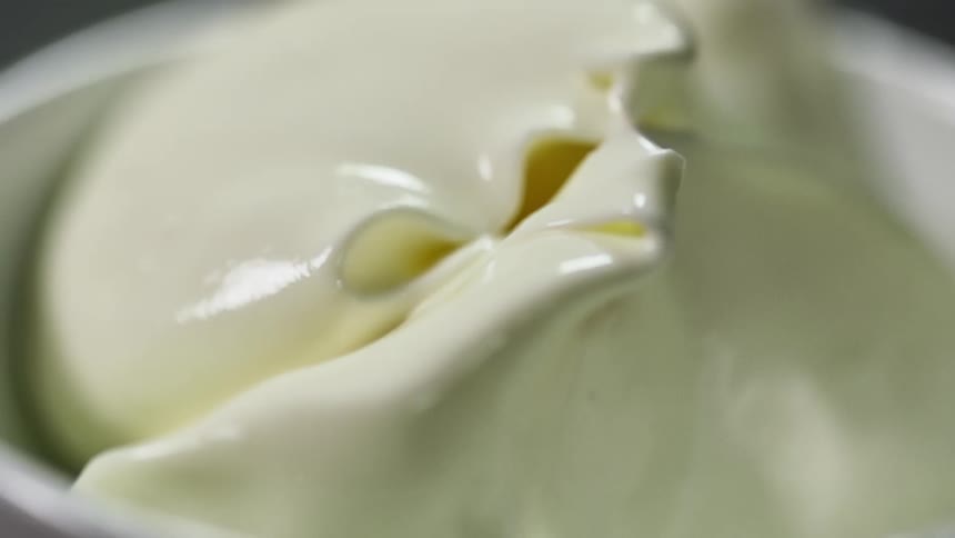 Mayonnaise being served inside a small white ceramic dish