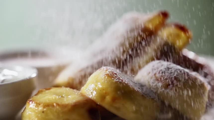 Powdered sugar sprinkles over dessert items