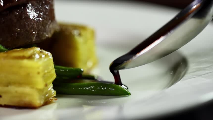 Sauce is being plated with food