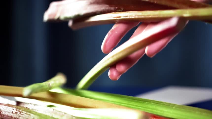 A man drops rhubarb on a counter