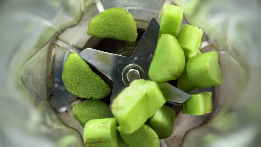 Pieces of kiwi are placed in the blender
