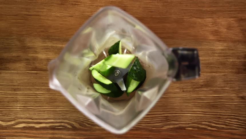 Green vegetables tossed into a blender