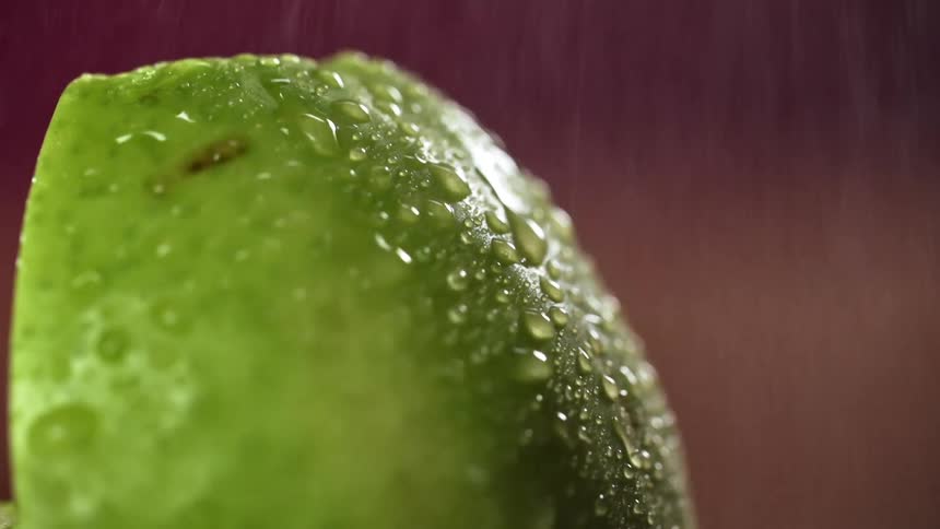 Green fruit sprayed with a fine mist of water