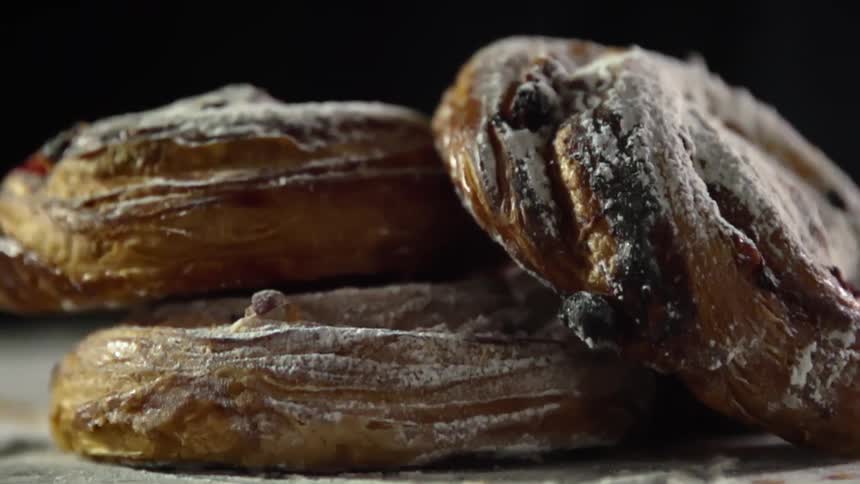 Three bread pastries sit on a table