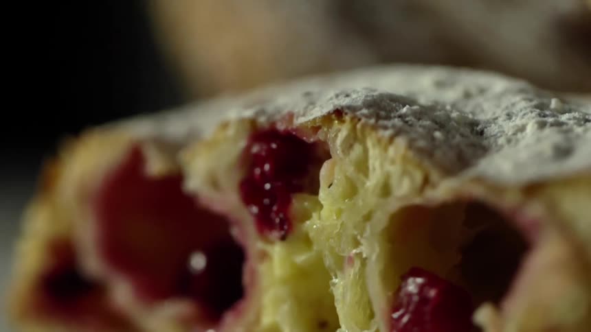 Powder falling atop a pastry stuffed with berries