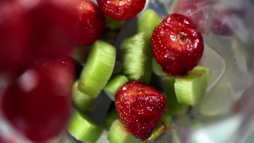 Fruit is dropped into the blender