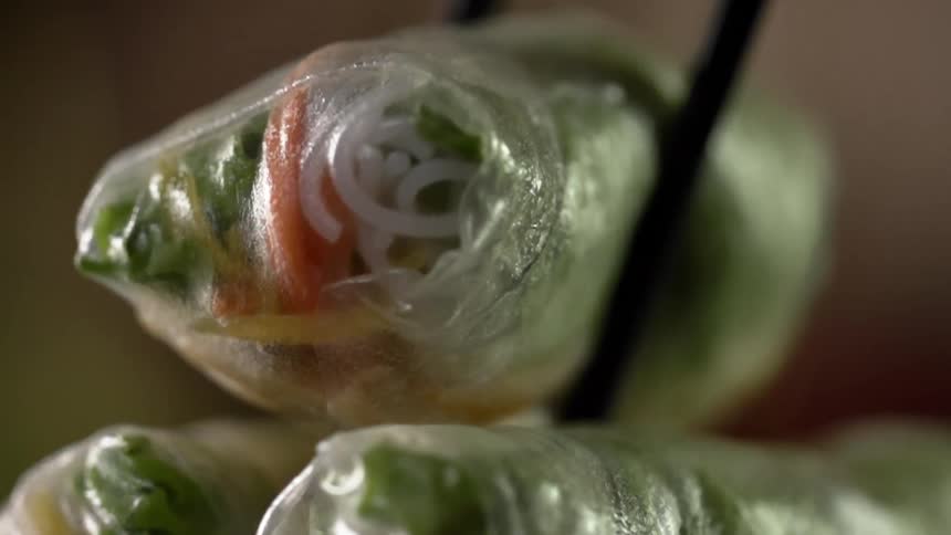 A vegetarian egg roll is placed on a stack