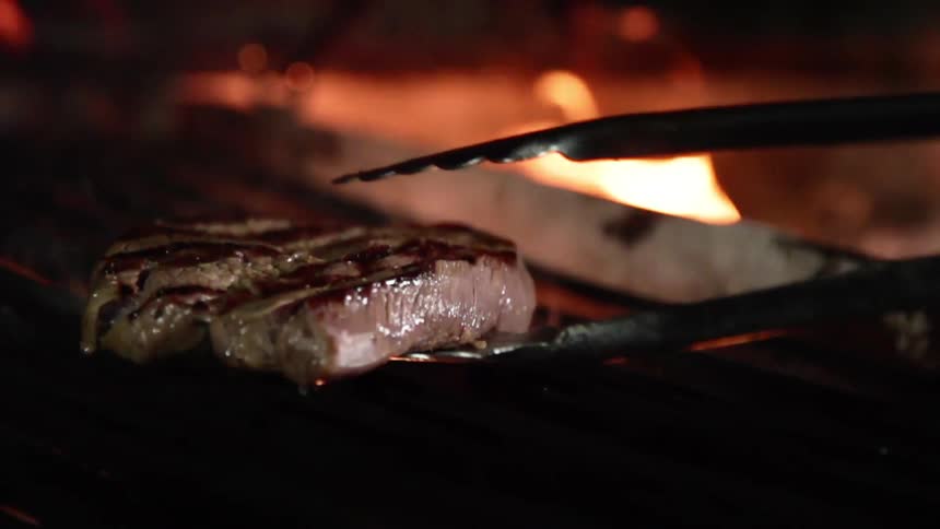 Meat being put on a grill