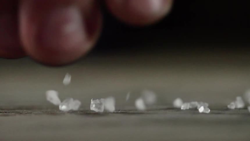 A man drops salts in a crack
