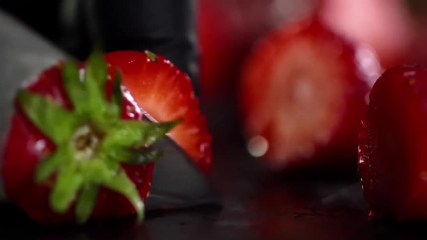Close up of strawberries being hulled