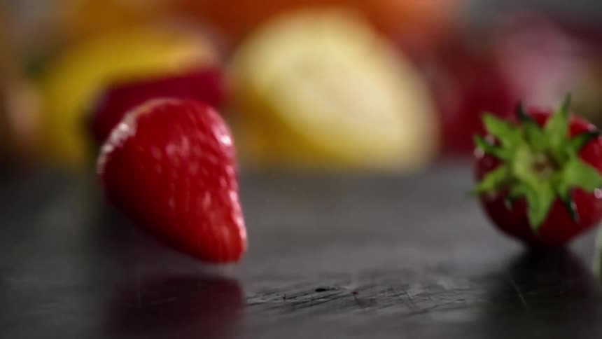 Strawberries dropping on to a table