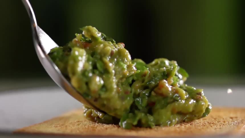 Toast is topped with a spoonful of guacamole