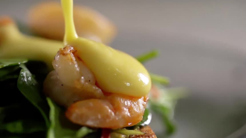 Sauce being poured over shrimp