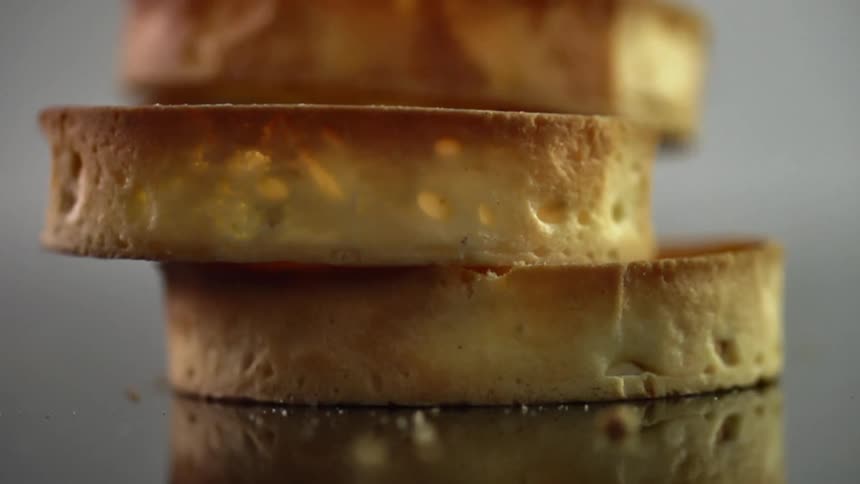 Three slices of toasted bread fall onto a table