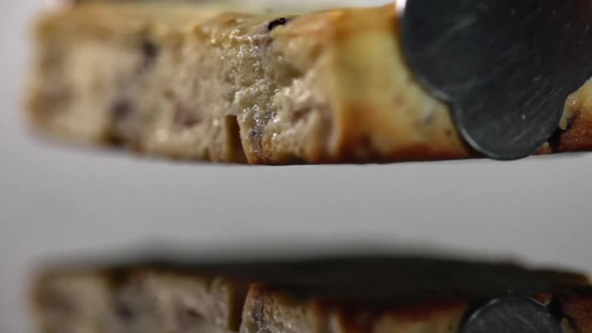 Slice of sweet cake drops on a reflective surface