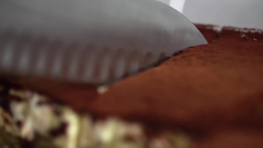 A knife cutting through a dessert