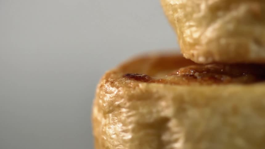A pastry drops on top of a similar food item