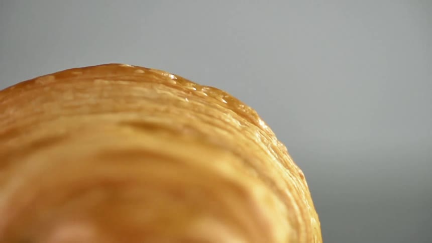 A person spins a croissant around