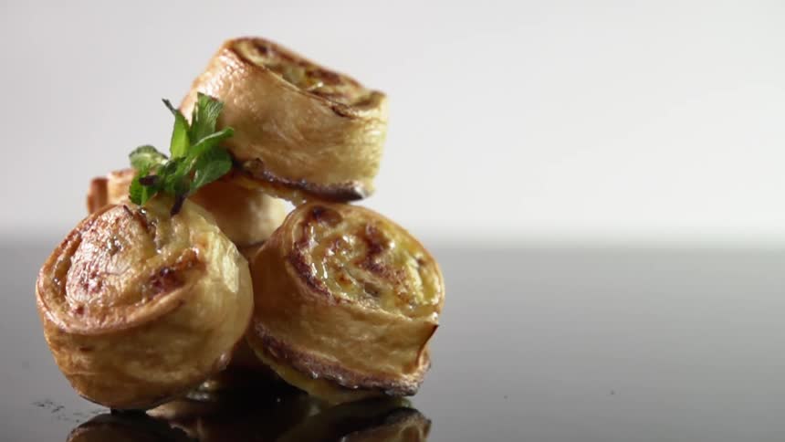 A garnish is dropped on pastries
