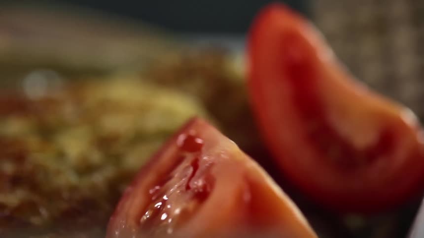 Tomatoes falling on a plate of food