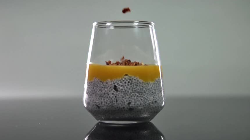 Garnish is dropped on the drink in the glass