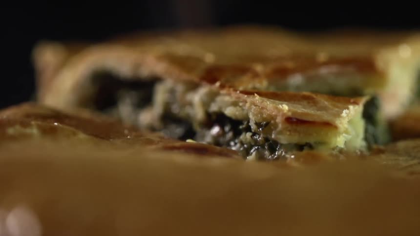 A piece of quiche being lifted up