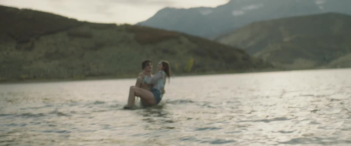 Man and woman splash and play in water