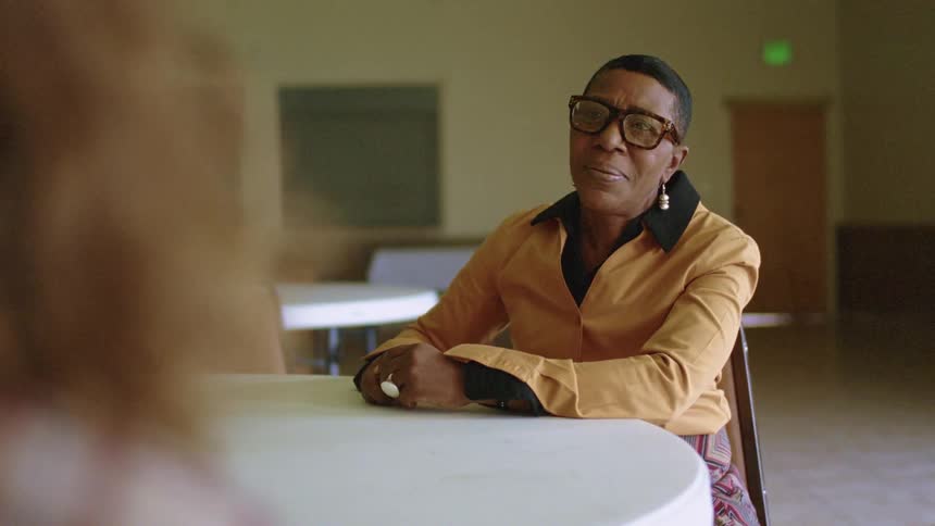 A teacher talks to a teenager who gets up and starts to storm out of the room