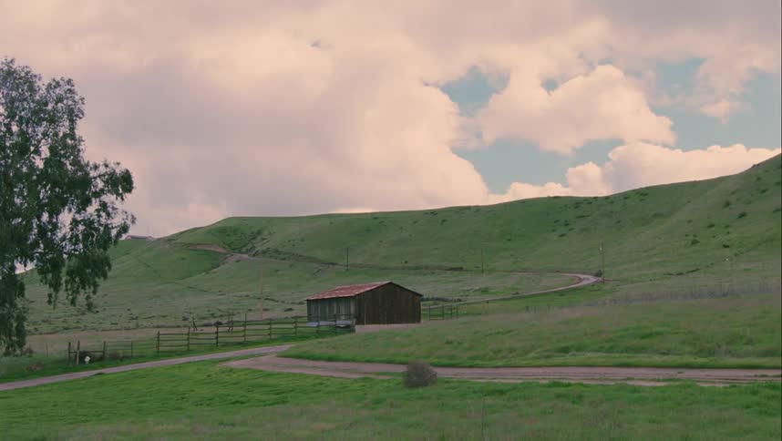 The heavy clouds are above the hills on the farm