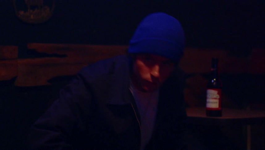 A man puts his beer down and walks off