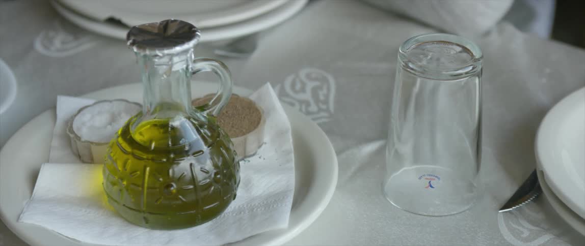 A table set with glassware, plates and condiments