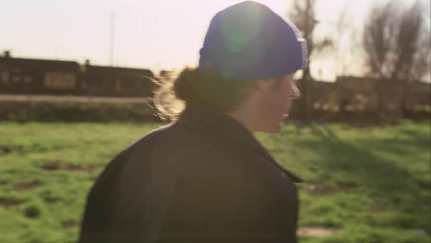 Man walks quickly repeatedly looking over his shoulder