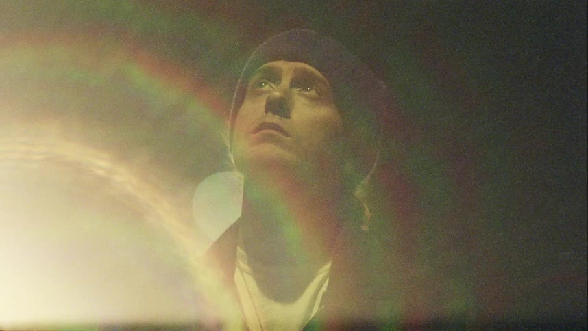 A light shines on a man at night