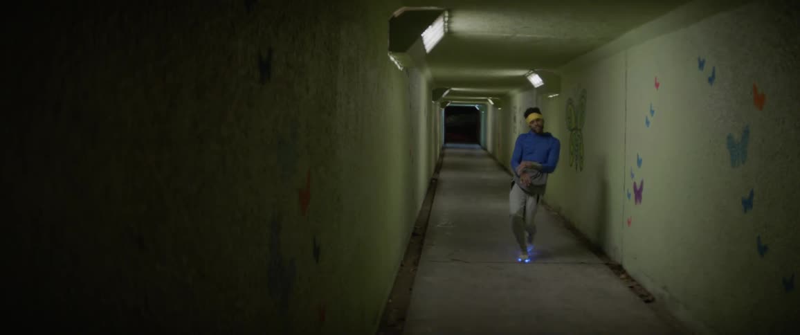 A man is dancing in the dark tunnel