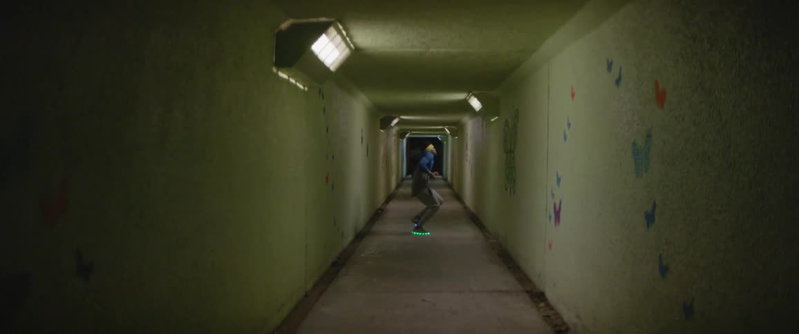 A man break dances wearing light up sneakers