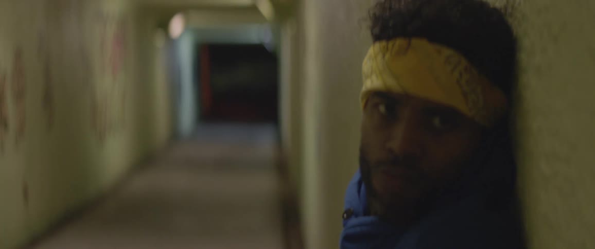 A man is dancing inside a tunnel at night