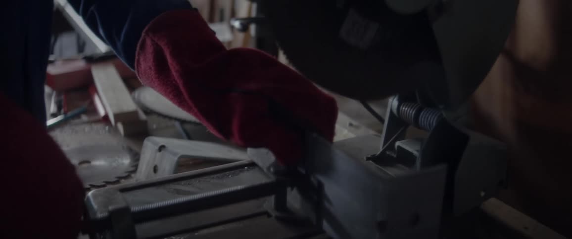 Person adjusting a tool in a workshop