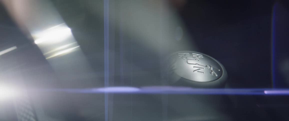 A driver shifts a gear knob
