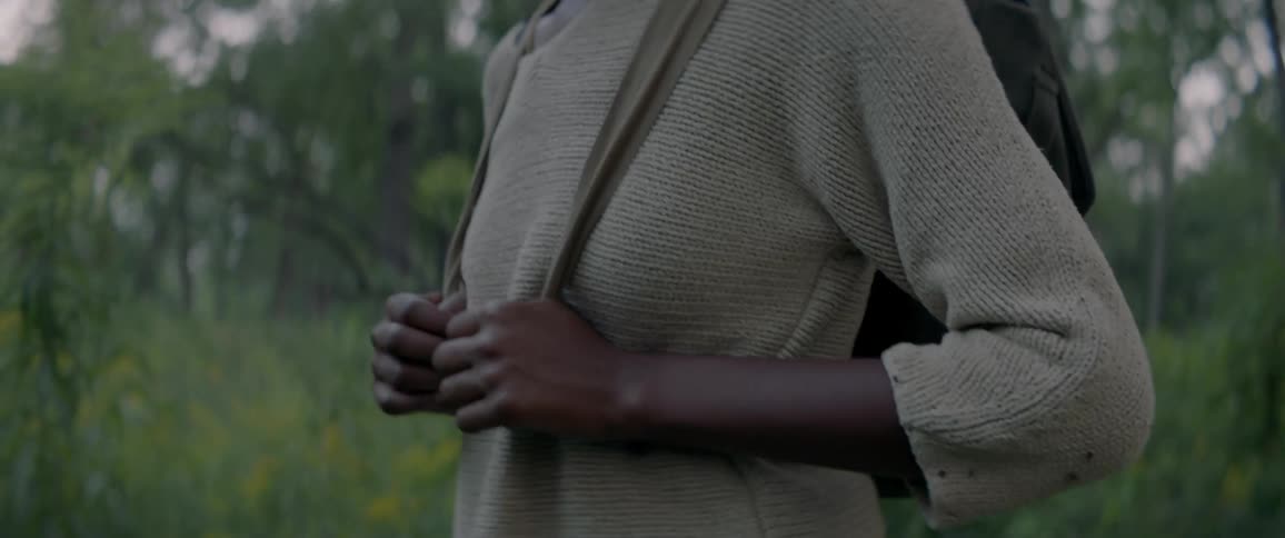 Woman hikes alone in a forest at sunset