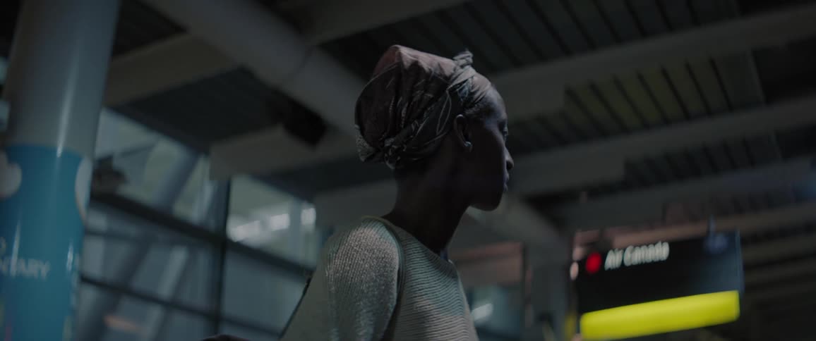 A woman looks confused and overwhelmed at the airport