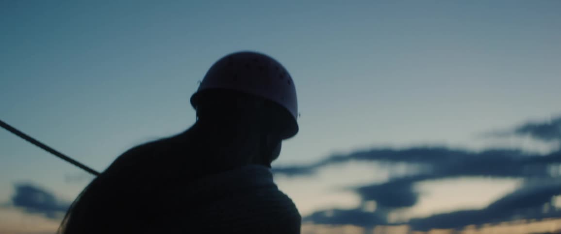 A person goes zip lining at dusk
