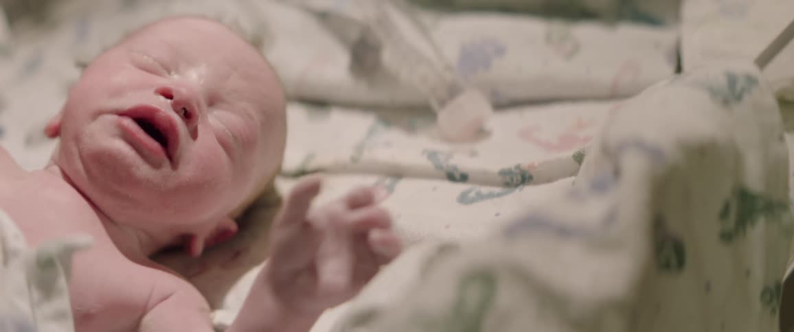 Crying infant waves its arm