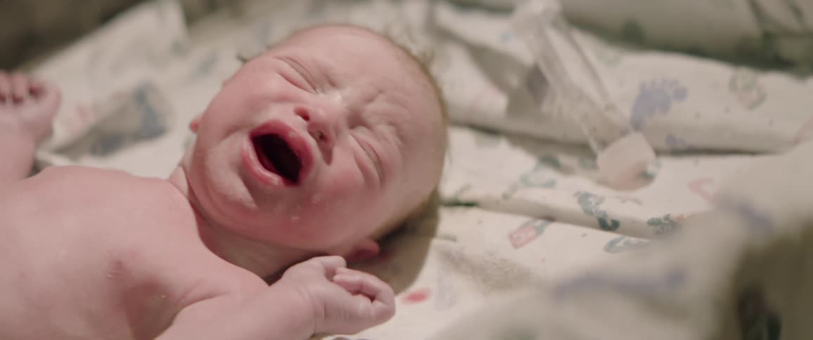 Baby cries as it lays in its crib