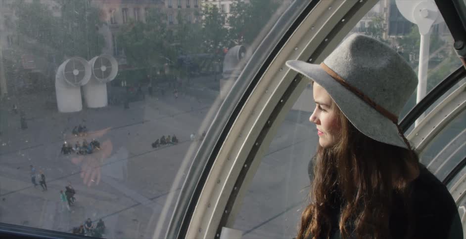 A woman riding an escalator through an observation tunnel