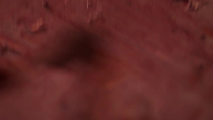 A person is scraping the painting with a tool