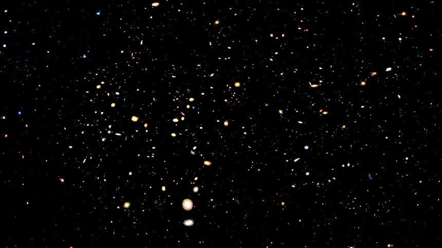 The dark void of outer space is filled with countless glowing stars and galaxies