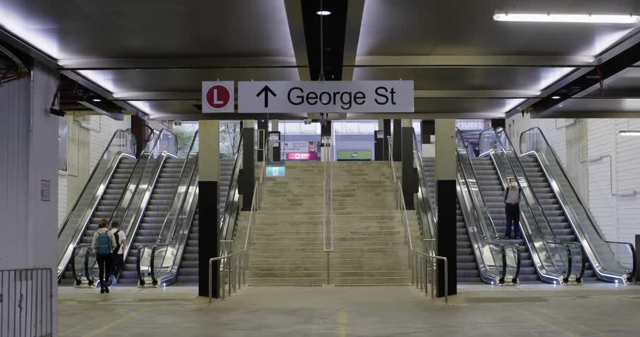 People travel on the escalators in the train station