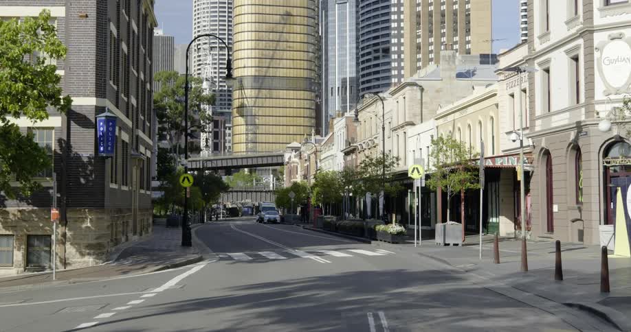 A police car is parked on an empty city street on a bright sunny day