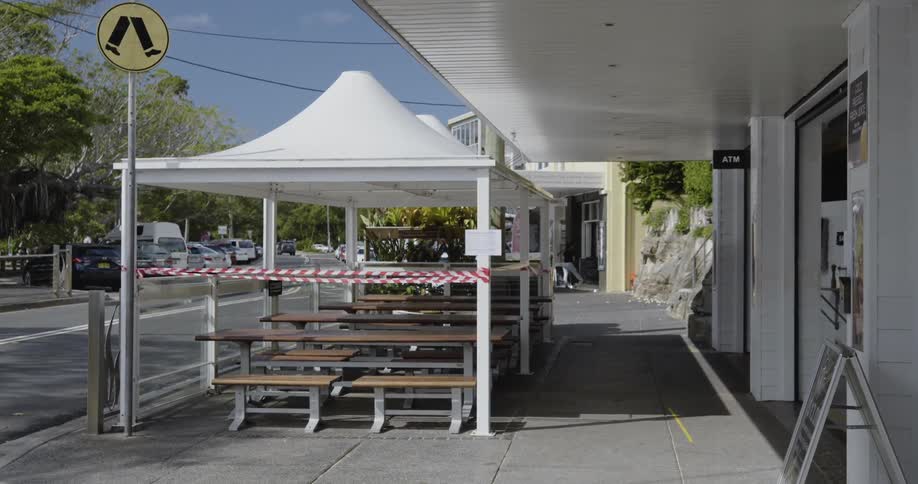 The seating is empty on the town sidewalk
